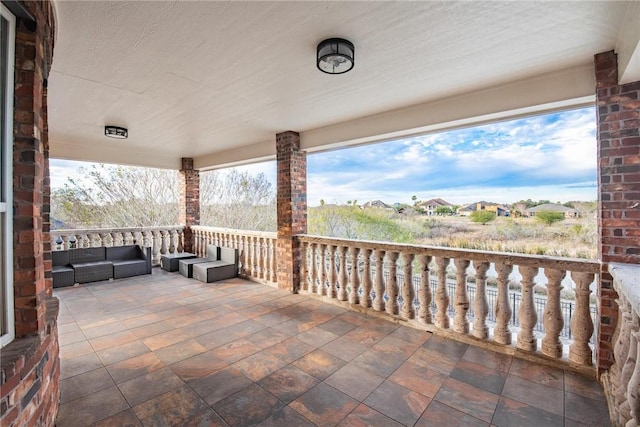 view of patio with a balcony and outdoor lounge area