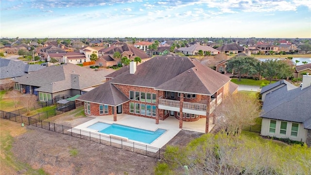 view of pool featuring a fenced in pool, a residential view, a patio, and a fenced backyard