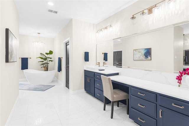 full bath featuring visible vents, baseboards, a chandelier, a freestanding tub, and vanity