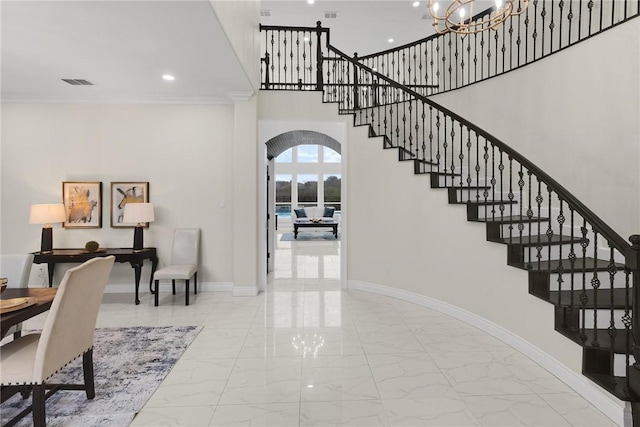 interior space with visible vents, baseboards, stairway, arched walkways, and marble finish floor