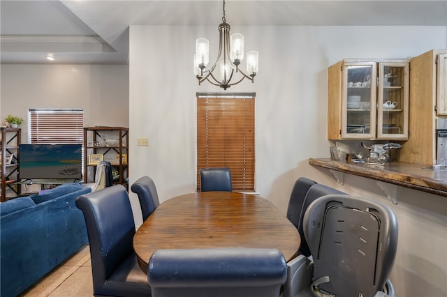 tiled dining room featuring an inviting chandelier