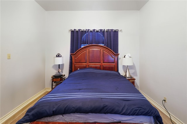 bedroom with hardwood / wood-style flooring