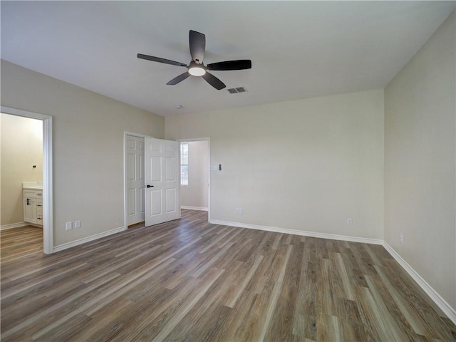 12631 Leopard St, Corpus Christi, TX 78410 - unfurnished bedroom with wood finished floors, ensuite bathroom, and a ceiling fan