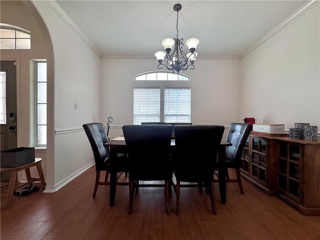 dining space featuring an inviting chandelier, arched walkways, ornamental molding, and wood finished floors