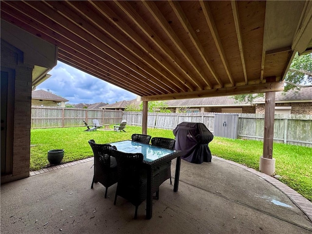 view of patio with outdoor dining space, a fenced backyard, and a grill