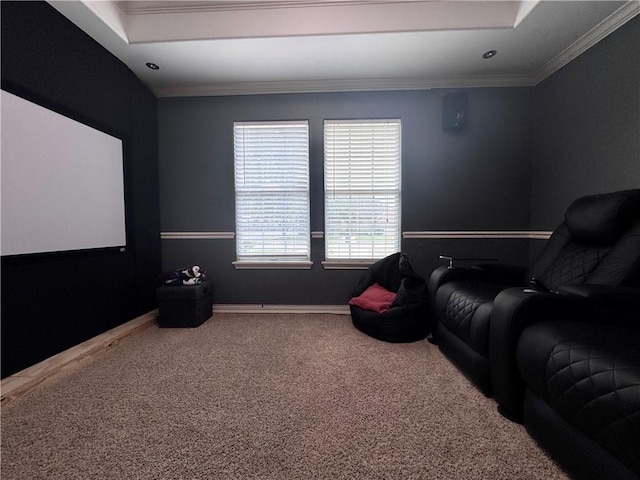 carpeted home theater featuring baseboards and ornamental molding