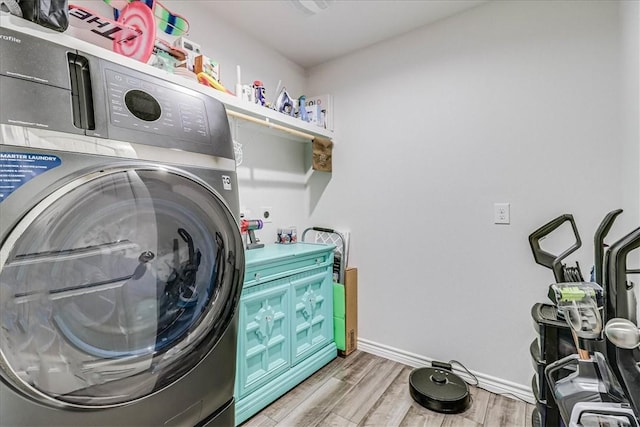 washroom featuring washer / clothes dryer and light hardwood / wood-style flooring