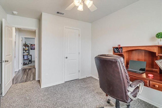 office space with ceiling fan and light carpet