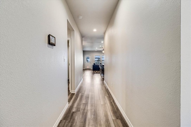 hallway with wood-type flooring