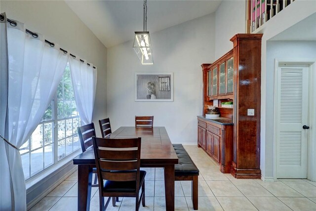 4409 Sue Cir, Corpus Christi, TX 78410 - dining room with high vaulted ceiling, light tile patterned floors, and baseboards