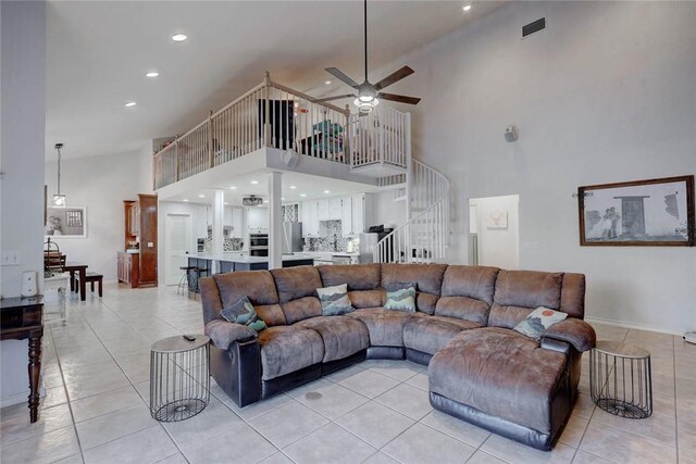 4409 Sue Cir, Corpus Christi, TX 78410 - living area with visible vents, light tile patterned floors, a ceiling fan, a towering ceiling, and stairs