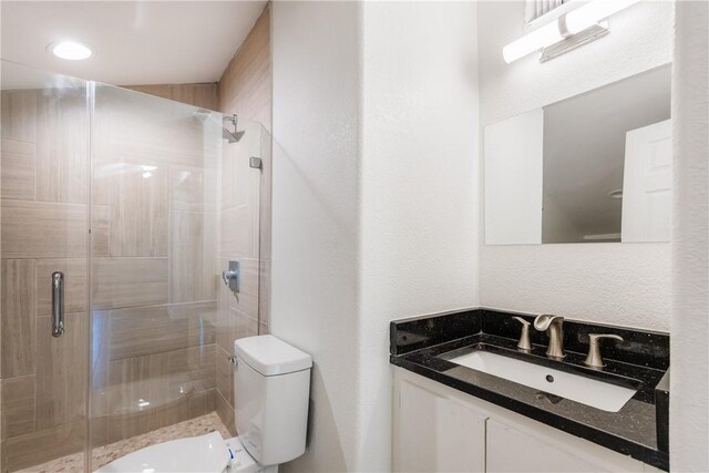 4925 Valley Stream Dr, Corpus Christi, TX 78413 - bathroom with toilet, a shower stall, and vanity