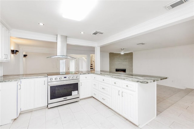 4925 Valley Stream Dr, Corpus Christi, TX 78413 - kitchen featuring stainless steel electric stove, island exhaust hood, light stone counters, a fireplace, and white cabinetry