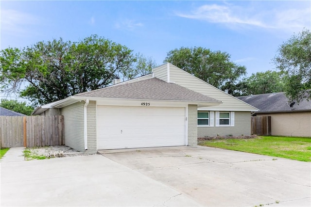 4925 Valley Stream Dr, Corpus Christi, TX 78413 - view of front of property featuring fence, a garage, concrete driveway, and brick siding
