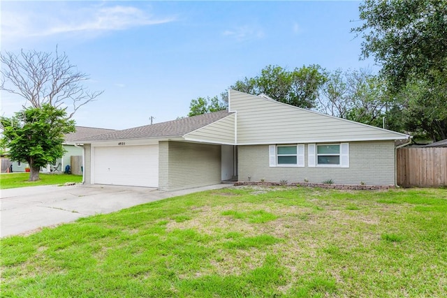4925 Valley Stream Dr, Corpus Christi, TX 78413 - mid-century home with an attached garage, driveway, and brick siding