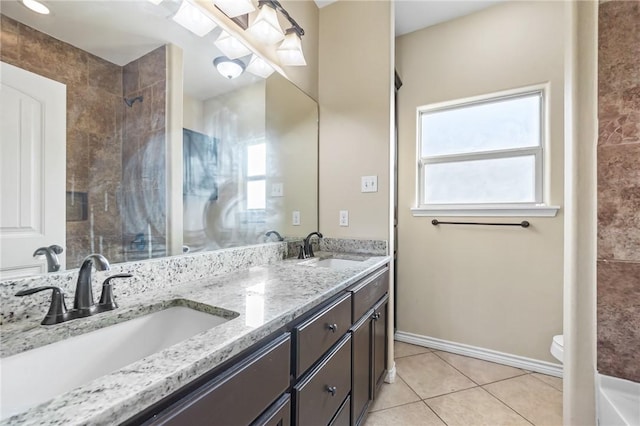 3813 Elvis Dr, Corpus Christi, TX 78414 - full bathroom featuring double vanity, healthy amount of natural light, tile patterned floors, and a shower