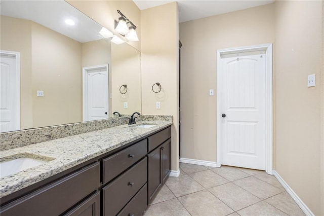 3813 Elvis Dr, Corpus Christi, TX 78414 - bathroom with double vanity, tile patterned flooring, and baseboards