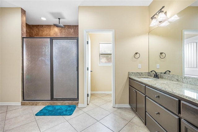 3813 Elvis Dr, Corpus Christi, TX 78414 - full bath featuring a stall shower, double vanity, tile patterned floors, and baseboards