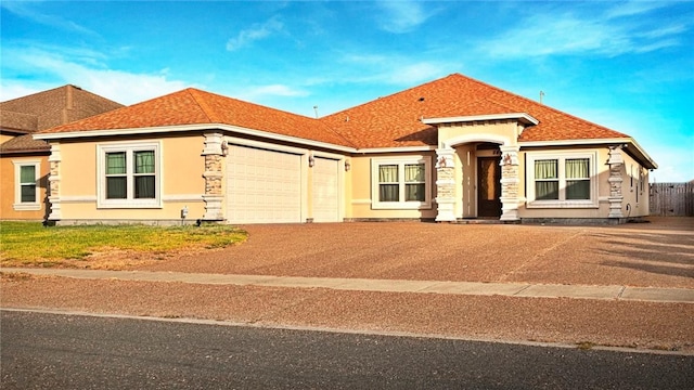 3813 Elvis Dr, Corpus Christi, TX 78414 - view of front of home featuring an attached garage, stucco siding, concrete driveway, stone siding, and roof with shingles