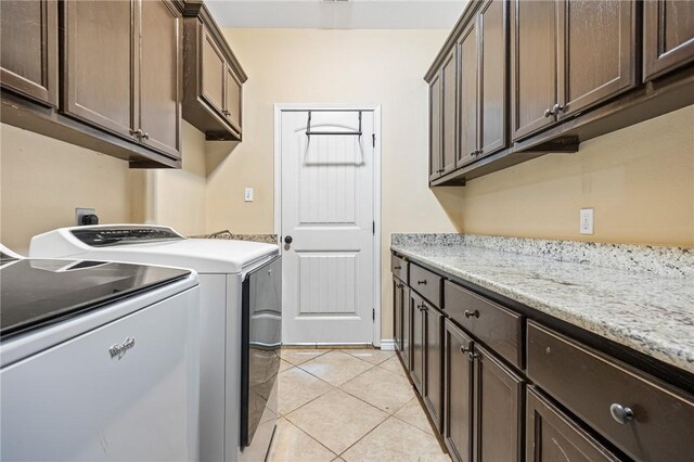 3813 Elvis Dr, Corpus Christi, TX 78414 - washroom with washing machine and dryer, cabinet space, and light tile patterned floors