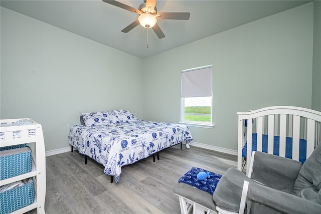 bedroom with hardwood / wood-style flooring and ceiling fan