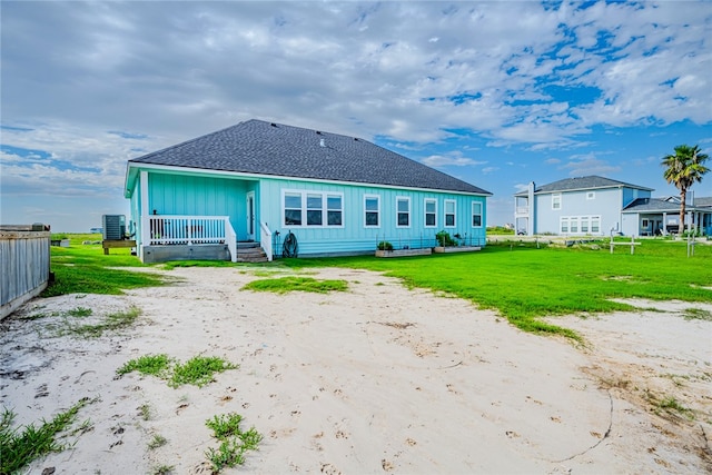 rear view of house with a lawn