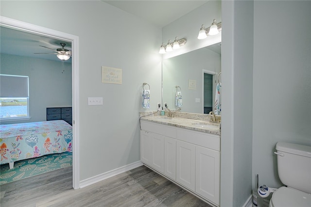 bathroom featuring hardwood / wood-style flooring, ceiling fan, vanity, and toilet