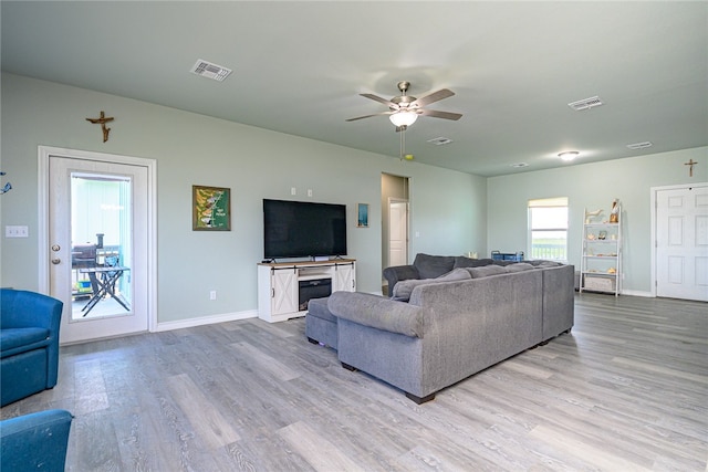 living room with light wood-type flooring and ceiling fan