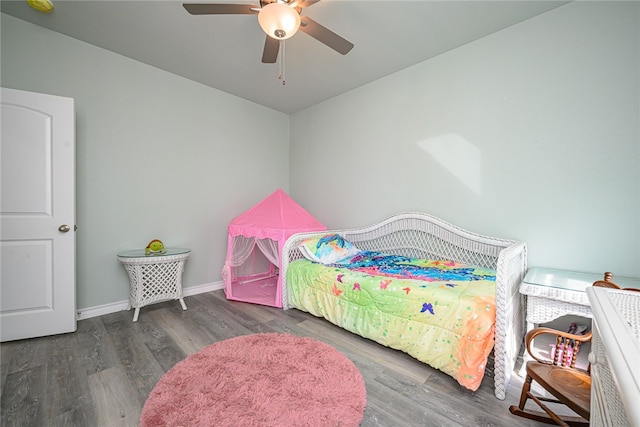 bedroom featuring ceiling fan and dark hardwood / wood-style floors