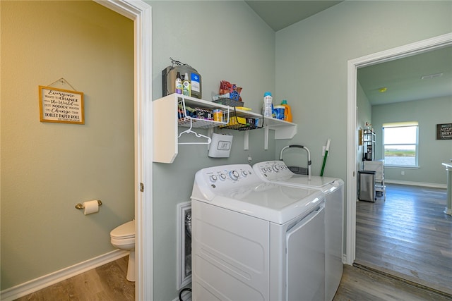 laundry room featuring hardwood / wood-style flooring and washer and dryer