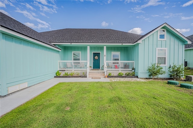 ranch-style house featuring a porch and a front lawn