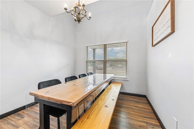 home office featuring dark hardwood / wood-style floors and an inviting chandelier