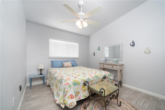 bedroom with light hardwood / wood-style floors, ceiling fan, and vaulted ceiling