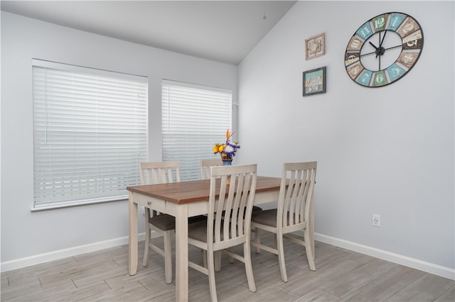 dining area featuring light hardwood / wood-style flooring and lofted ceiling