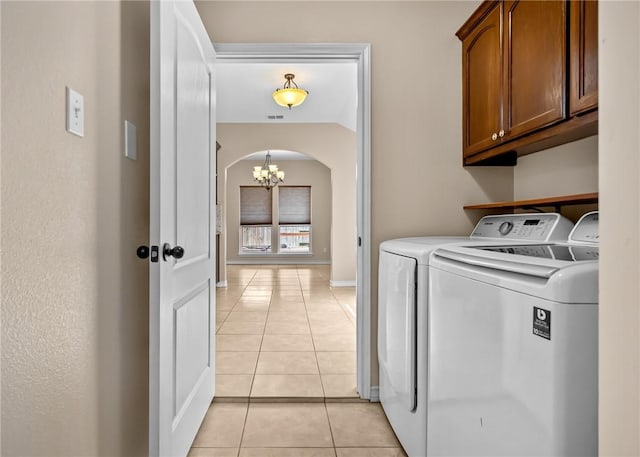 7406 Brush Creek Dr, Corpus Christi, TX 78414 - washroom with cabinet space, washing machine and clothes dryer, a chandelier, arched walkways, and light tile patterned flooring
