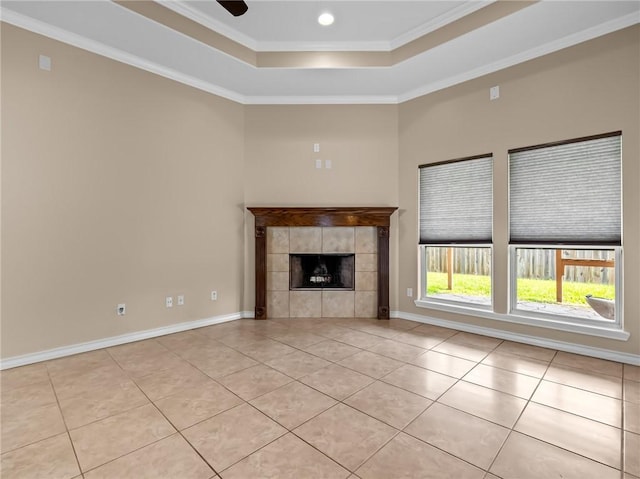 7406 Brush Creek Dr, Corpus Christi, TX 78414 - unfurnished living room featuring a tray ceiling, light tile patterned floors, ornamental molding, a tile fireplace, and baseboards