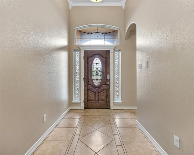 7406 Brush Creek Dr, Corpus Christi, TX 78414 - foyer entrance with arched walkways, light tile patterned flooring, crown molding, baseboards, and a towering ceiling