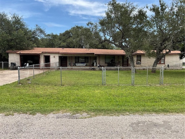 3128 Hackberry Ave, Ingleside, TX 78362 - single story home featuring a fenced front yard, a garage, driveway, and stone siding