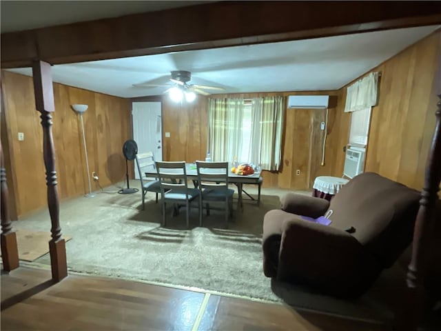 3128 Hackberry Ave, Ingleside, TX 78362 - dining room with a wall mounted AC, wood walls, and ceiling fan