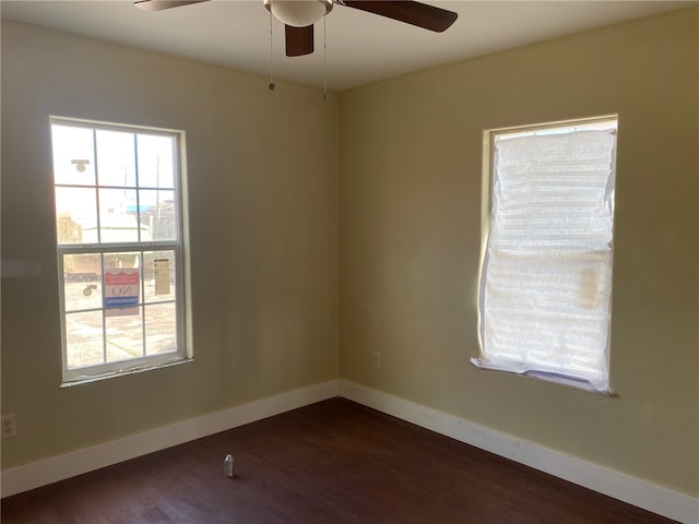 unfurnished room featuring dark wood-type flooring and ceiling fan