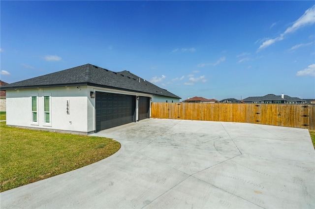 view of home's exterior featuring a garage and a yard