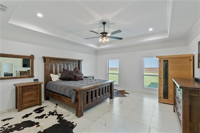 bedroom with ceiling fan, crown molding, and a tray ceiling