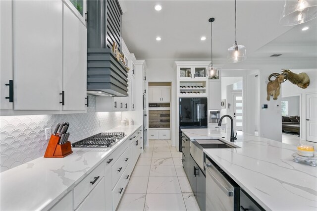 kitchen with white cabinetry, a wealth of natural light, appliances with stainless steel finishes, and pendant lighting