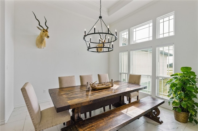 dining area featuring a chandelier and crown molding