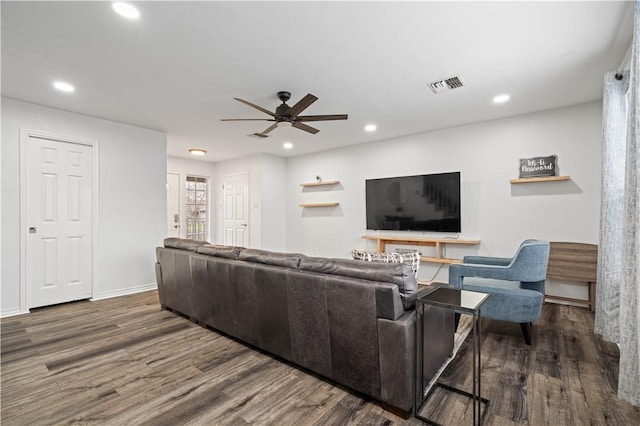 living area featuring dark wood-type flooring, visible vents, and recessed lighting