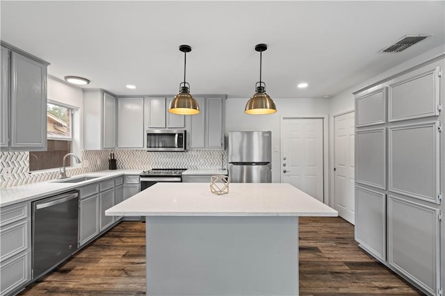 kitchen with stainless steel appliances, light countertops, and a center island