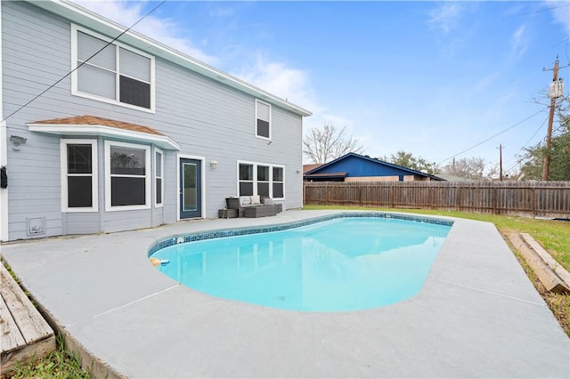 view of swimming pool featuring a fenced in pool, a fenced backyard, and a patio