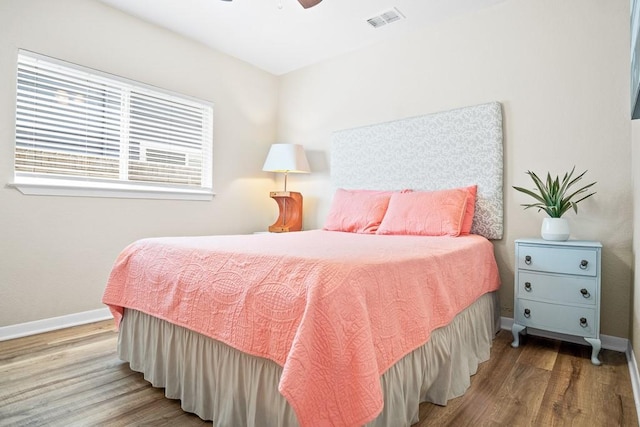 906 S Young St, Rockport, TX 78382 - bedroom featuring visible vents, baseboards, a ceiling fan, and wood finished floors