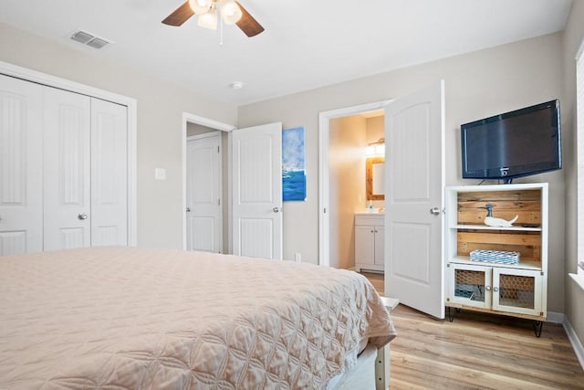 906 S Young St, Rockport, TX 78382 - bedroom featuring visible vents, a closet, ceiling fan, light wood-type flooring, and ensuite bath