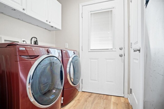 906 S Young St, Rockport, TX 78382 - laundry area with cabinet space, light wood-style flooring, and separate washer and dryer